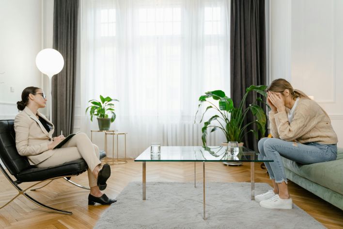 A therapist and a client in a modern office setting during a counseling session.