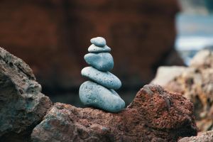 Peaceful arrangement of balanced stones in an outdoor rocky setting, symbolizing harmony.