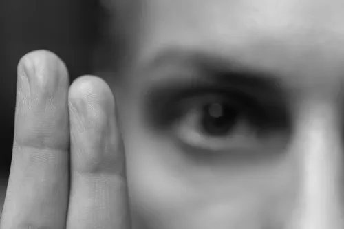Woman watching two fingers move side to side in EMDR therapy treatment